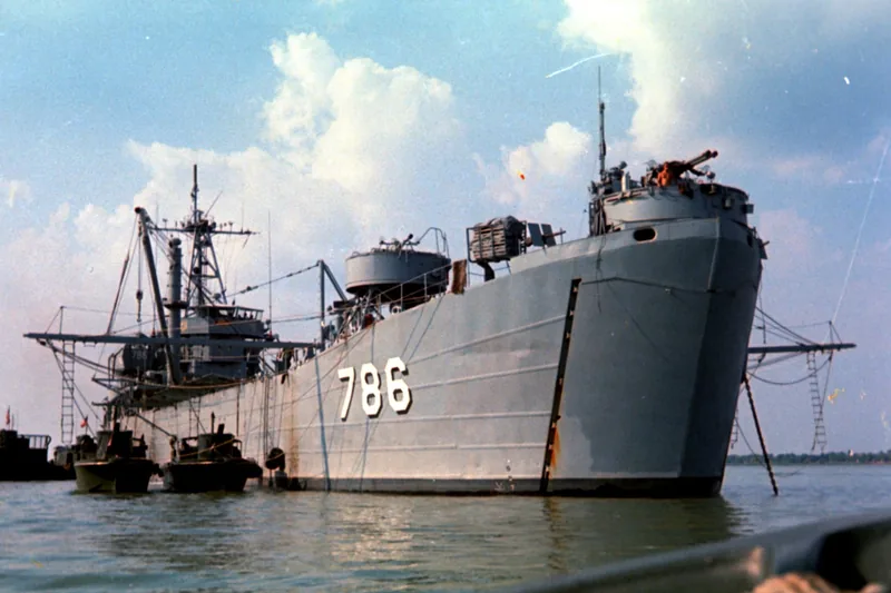 A gray military landing ship numbered 786 anchored on a river in the Mekong Delta. A gray military landing ship numbered 786 anchored on a river in the Mekong Delta.