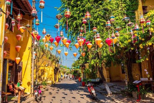 Yellow merchant-house façades and lanterns on a Hoi An old town lane Yellow merchant-house façades and lanterns on a Hoi An old town lane